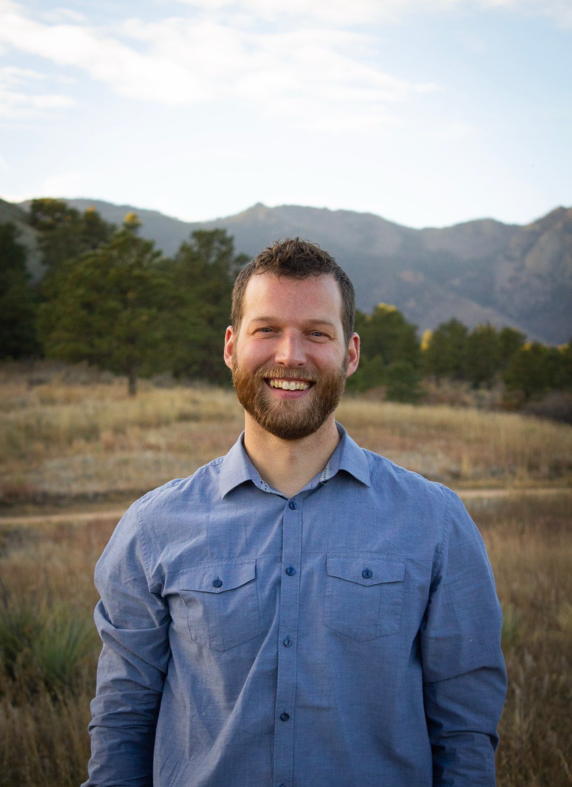 Nate, founder of Steward Holdings, smiling outdoors